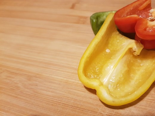Peppers On A Deodorised Chopping Board.