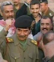Saddam Hussein with an Army behind him
