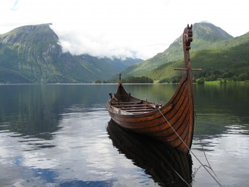 Resting tethered in a Norwegian fjord, a Viking vessel awaits its crew