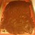 The melted chocolate has been dispersed evenly over the surface of the toffee. The melted chocolate has been dispersed evenly over the surface of the toffee.
