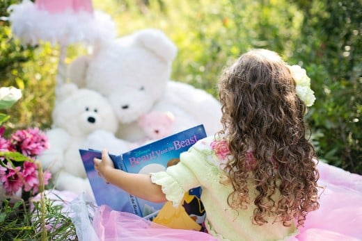 Little Girl Reading to Her Bears