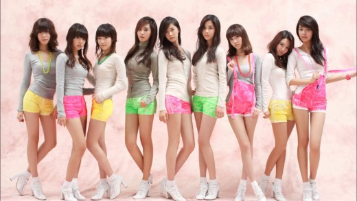 Girls' Generation posing in their iconic white or grey shirts and colored bottoms, the outfits used on "Gee."