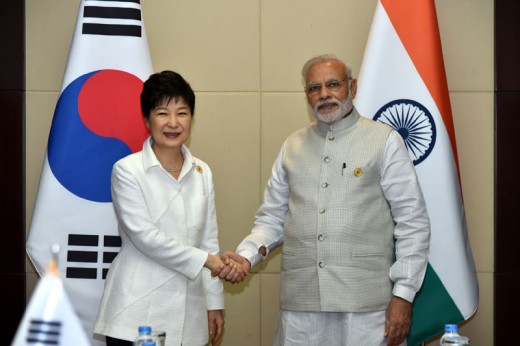 	 the Prime Minister of India, Shri Narendra Modi shaking hands with the President of South Korea, Ms. Park Geun-hye