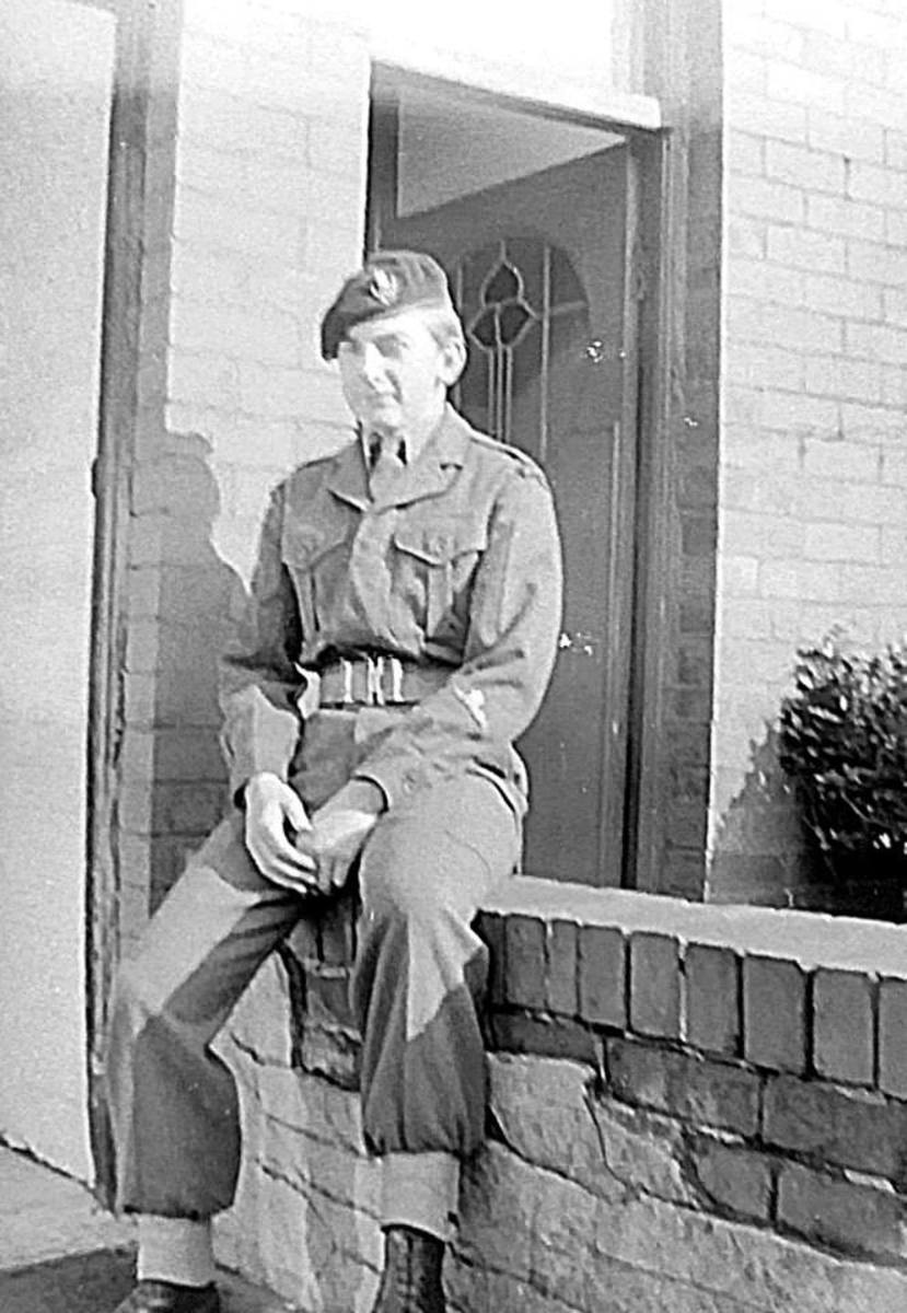 Eric in his Army Cadet uniform, sitting on the wall of my grandma's guest house