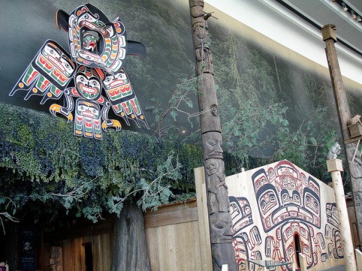 Tsimshian art on an indigenous house, with related native-carved poles.