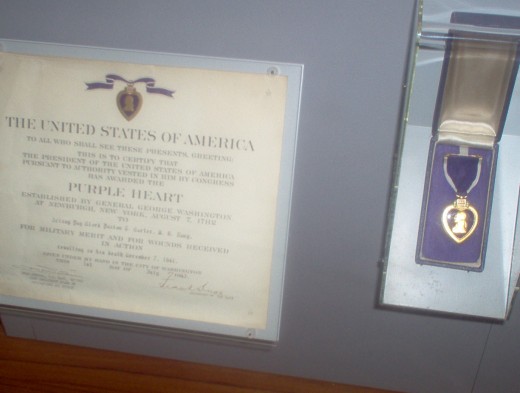 A fallen soldiers purple heart in museum. 