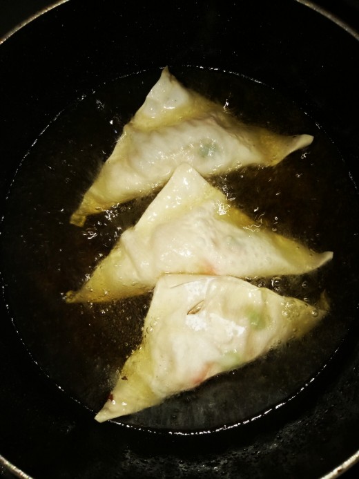 4. Heat oil in a pan. Deep fry the wrapped vegetable until golden brown.  