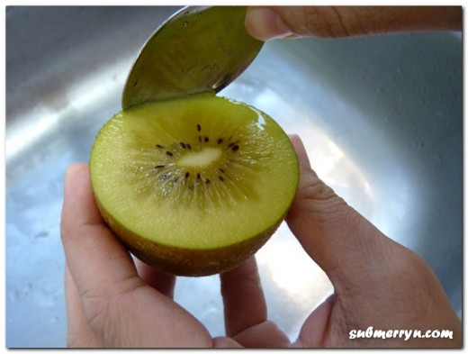 Insert the spoon underneath the skin on the edge of the fruit's flesh. 