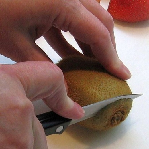 Cutting the ends of the kiwi makes it easy to insert the spoon. 