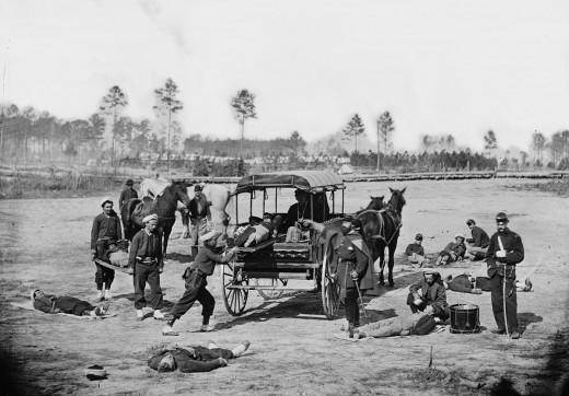 American Zouave ambulance crew demonstrating removal of wounded soldiers from the field with horses and a wagon during the American Civil War. between 1862 and 1865 