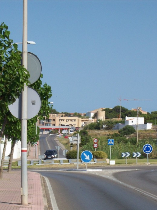 Walking in via the main road turn left at this roundabout and cut through the streets of Es Castell. This image is from a previous visit before the second iconic windmill was restored