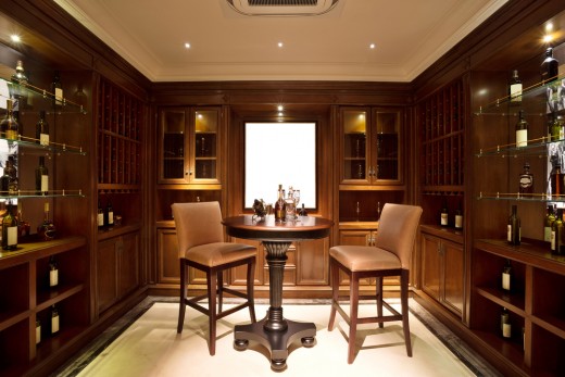 Simple tasting area in the middle of a modest wine collection.