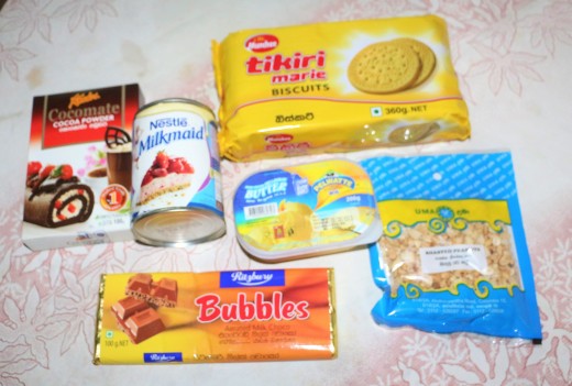 Cocoa Powder, Condensed milk tin, Butter, Marie Biscuit Packet, Peanuts and Milk Chocolate Bar