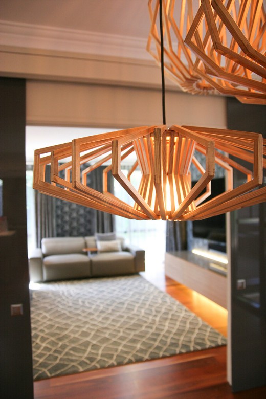 A grouping of susprension light fixtures and LED strip lighting under floating console create an effect achieved only with differing layers and types of lighting