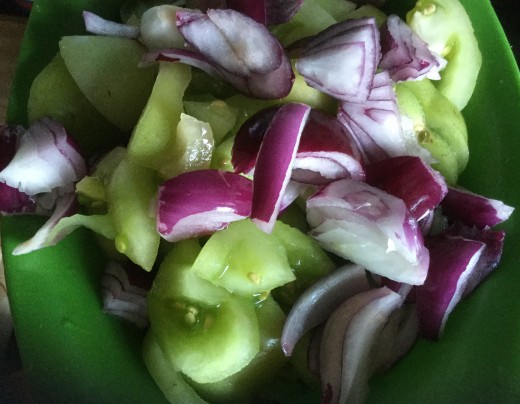 Prepared green tomatoes and red onions