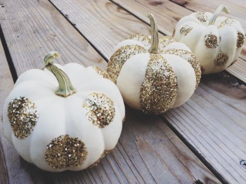 Simple craft glitter transforms little pumpkins into stylish place card holders.