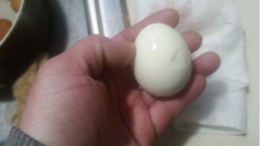 Here is your hard boiled egg, ready to rinse and use. You'll have to wash off any small bits of egg shell.