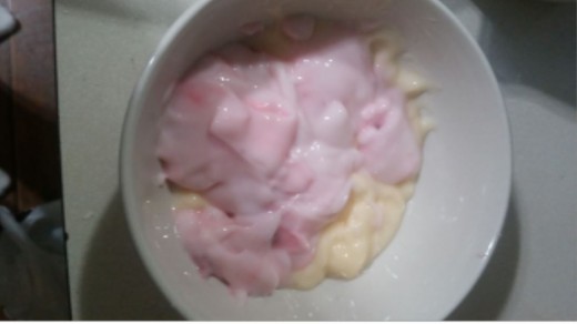 Dump orange creme yogurt and strawberry yogurt in bowl