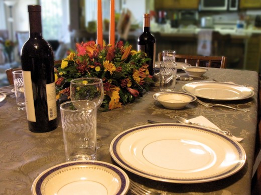 A festive flower arrangement with candles, your pretty china, and a nice tablecloth make your holiday meal special. 