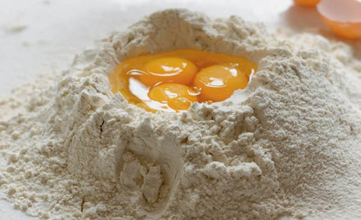 Form mound of flour and create a well in the center, add eggs to the well