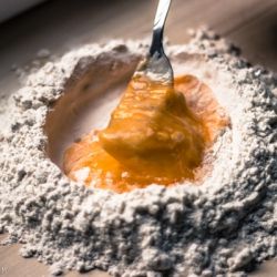 Slowly beat eggs while incorporating flour
