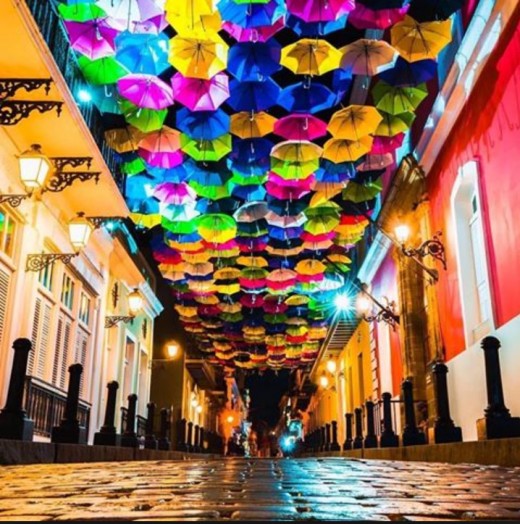 Cobblestone streets with lit up umbrellas