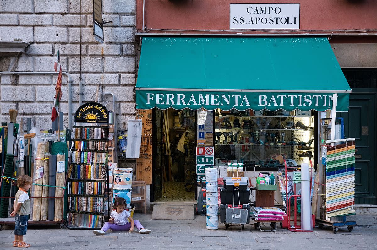 Children playing in front of a hardware store in Venice.