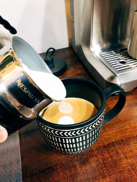 Pour the milk into the prepared cup of coffee that is brewed earlier. 