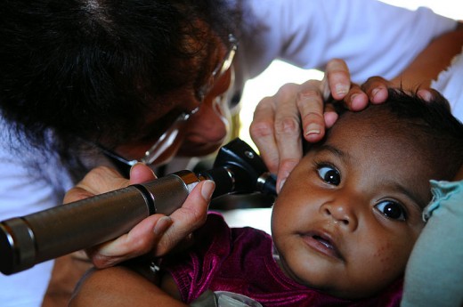 A child being checked for the ear infection