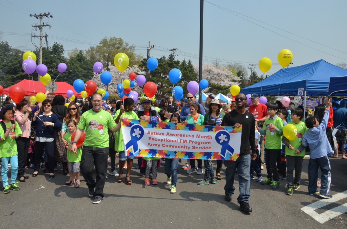 Community members march during the Autism Walk at the Fun Fair on Yongsan Garrison, April 11, 2019. Army Community Service members and volunteers pass out Autism Awareness balloons for everyone to hold.