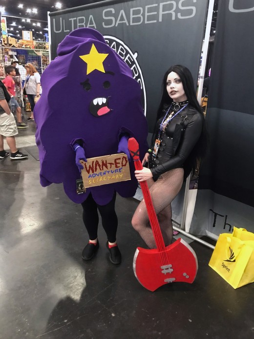 My wife as Lumpy Space Princess/LSP on the left and a cosplayer as Marceline on the right. Both are from Adventure Time. My wife made her costume from scratch. Comicpalooza 2019 day three. 