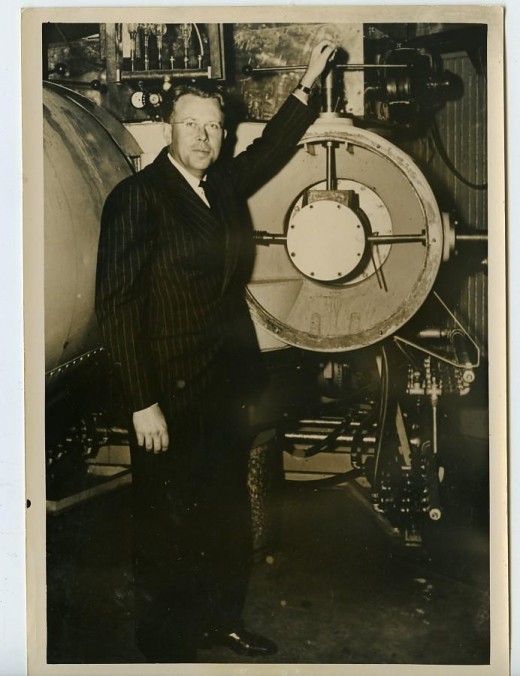 Nobel laureate Ernest Lawrence, inventor of the Cyclotron, with an early model of the machine
