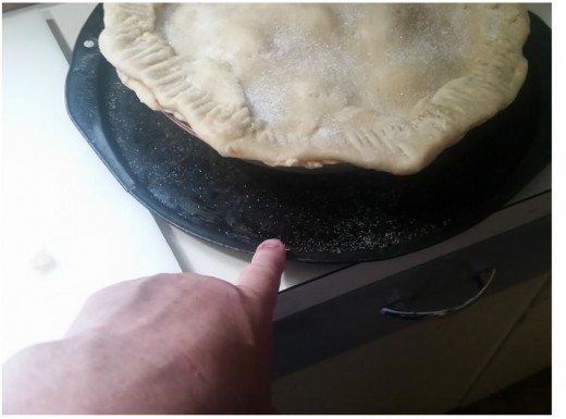 place pie on pizza pan to catch drippings