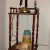 This is an old fashion phone stand. The phone on it is the kind you held separatly to hear/talk. On the phone book shelf I have a stack of round boxes! (I love boxes too!):)
