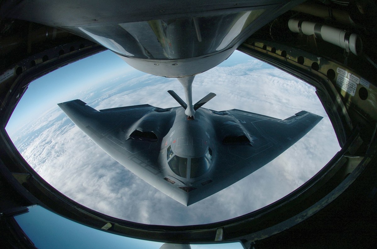 A B-2 during aerial refueling which extends its bombing  range past 6,000 nautical miles (6,900 mi; 11,000 km) for intercontinental sorties.