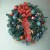 You can take a plain wreath from a craft store and give it a big bow and accents like this one.