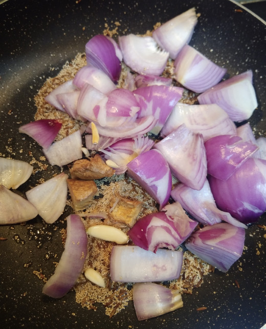 To this add chopped onion, ginger and peeled garlic. (If you are using store brought ginger-garlic paste add in this step).