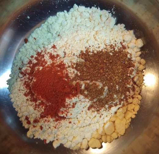To this gram floor add red chili powder and garam masala powder.
