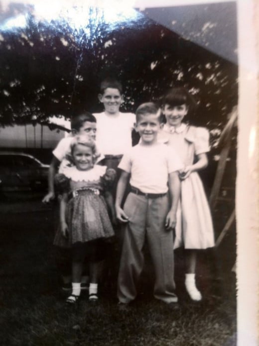 My cousin, Jimmy, in the middle, was served a slice of dirt cake from my make-believe kitchen.