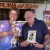A brilliant yet simple man:  Jimmy with Lupe and "Mini" In front of store and holding copy of book.