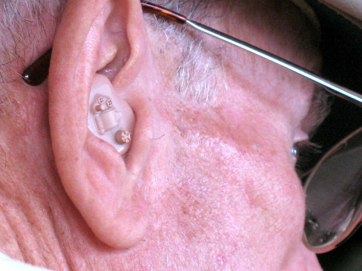 Man wearing hearing aid and eyeglasses