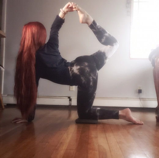 Working on shoulder flexibility with a flipped grip in tiger pose.