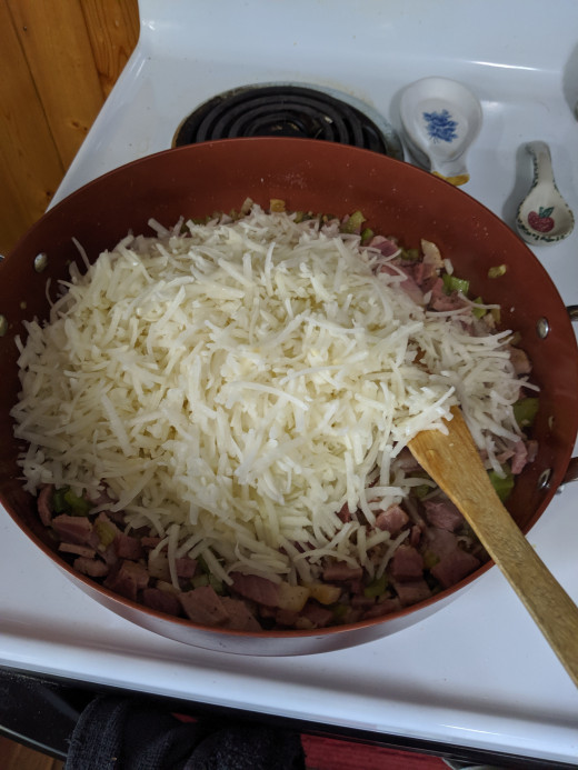 Add potatoes to ham mixture and stir to coat