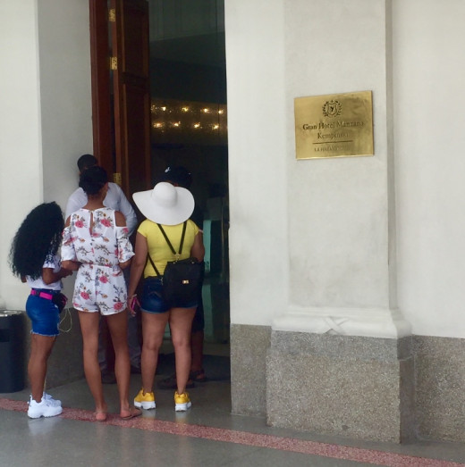 Tourists outside a luxury hotel in the heart of Havana.