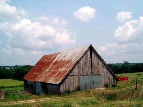 I love the settings that many barns are found in.  This is so relaxing to me, peaceful.  The clouds and blue sky are so welcome a view. 