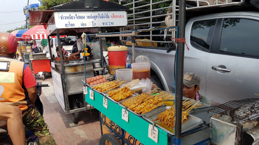 A street merchant along a strip of road in Bangkok.