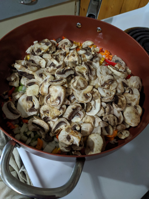 Dump all of the vegetables, mushrooms and chicken on the melting butter, and saute while rice is cooking