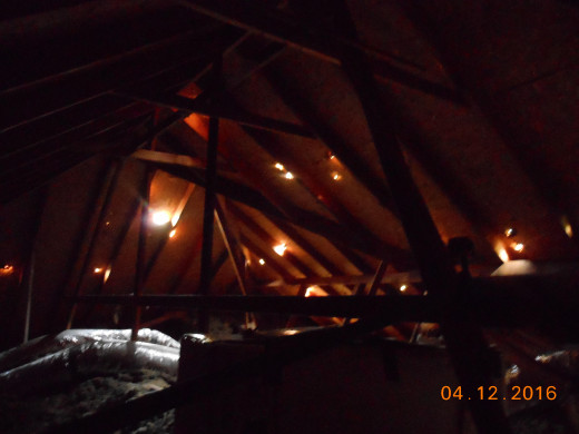 Picture from inside attic showing how hail came through the roof 