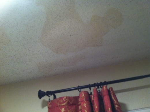 Ceiling damage from water leaking in after hail punched holes in roof. Tip: If you see water stains like this, poke a hole in ceiling to allow water to drain