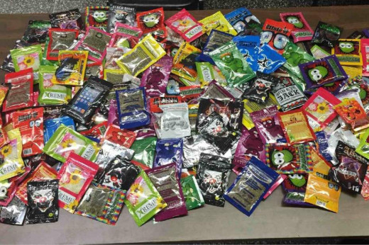 This photo provided Aug. 7, 2015 by the New York Police Department shows packets of synthetic marijuana seized after a search warrant was served at a newsstand in Brooklyn, N.Y.